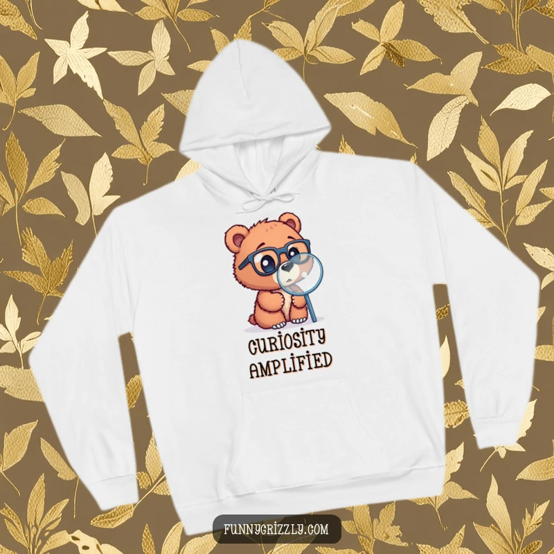 Funny hoodie showcasing a curious grizzly bear cub with glasses, looking through a magnifying glass, a warm and charming item.