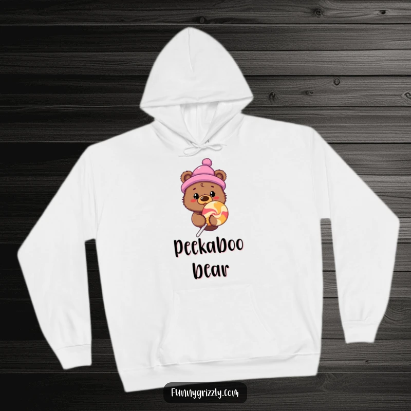 Funny curious grizzly bear in a novelty hat peeking from behind a giant lollipop, featured on a cozy hoodie.
