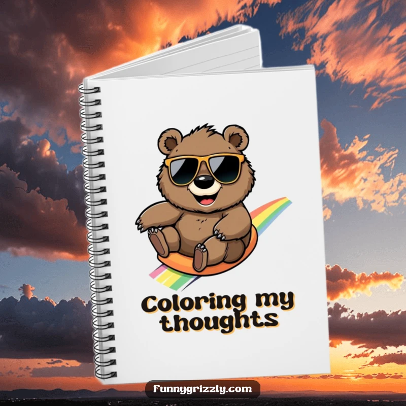 Funny round grizzly bear with sunglasses sliding down a rainbow, on the cover of a whimsical and humorous notebook.
