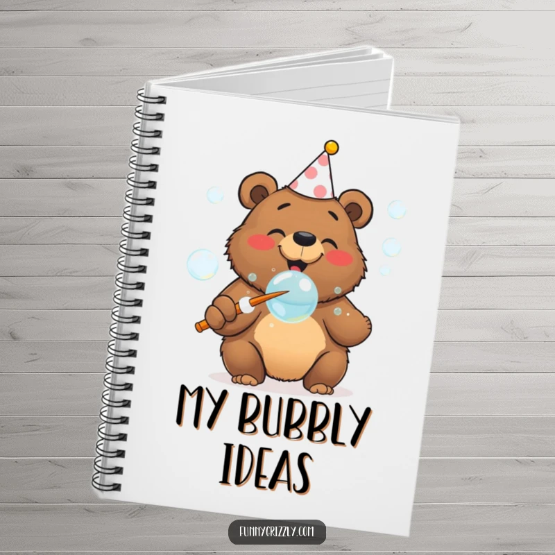 Funny cheerful grizzly bear in a party hat blowing bubbles with a huge wand, on the cover of a festive notebook.