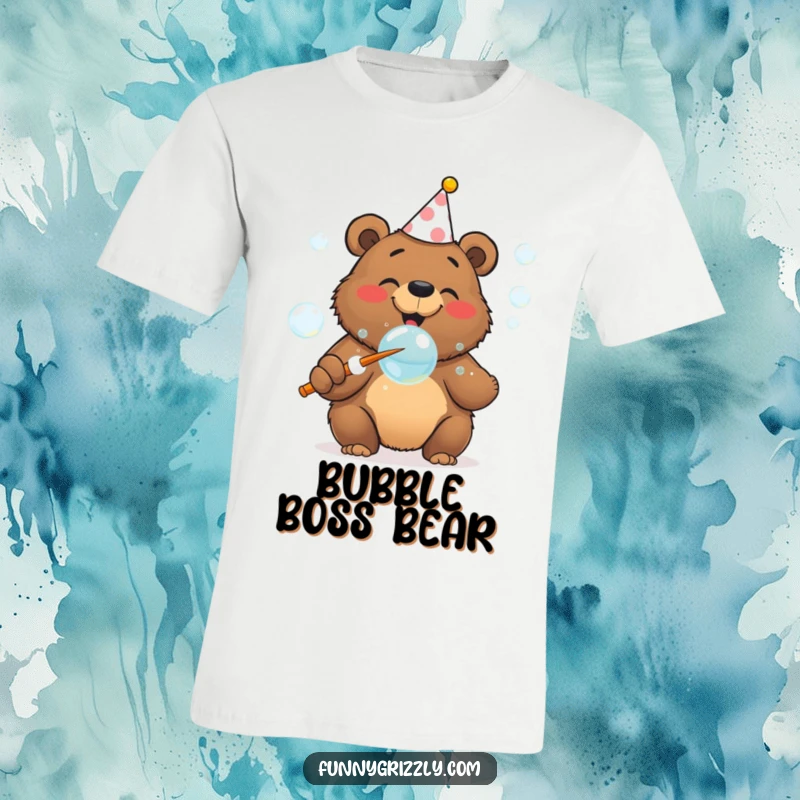 Cheerful grizzly bear wearing a party hat gleefully blows bubbles with a giant wand on a festive graphic t-shirt.