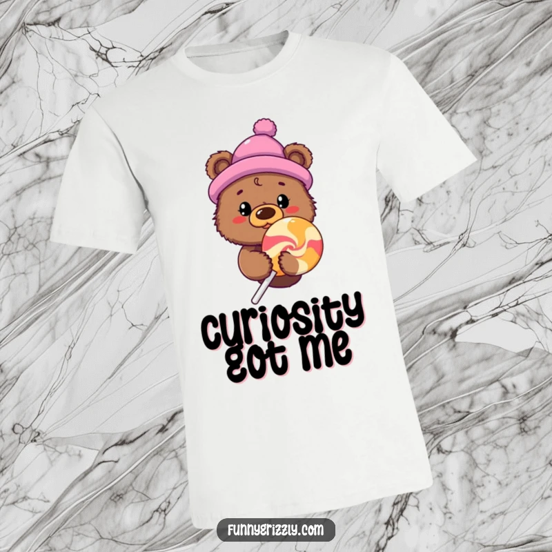 Curious grizzly bear wearing a novelty hat peeks behind a giant lollipop on a fun graphic t-shirt.