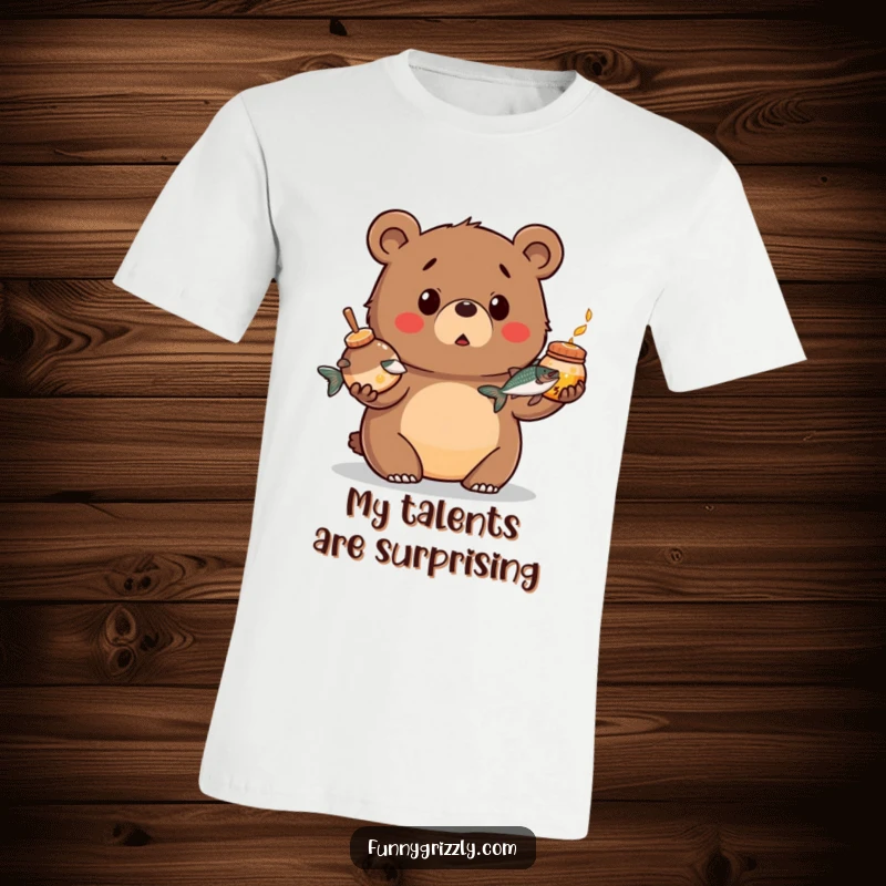Funny t-shirt of a chubby grizzly bear looking surprised while juggling a honey pot and a salmon, capturing a moment of comical bewilderment.