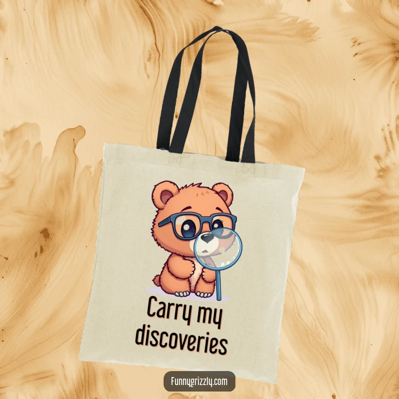 Funny tote bag featuring a curious grizzly bear cub wearing glasses, exploring with a magnifying glass, a stylish accessory.