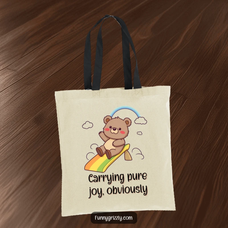 Funny tote bag illustrated with a happy grizzly bear sliding down a colorful rainbow, perfect for carrying daily items with a smile.